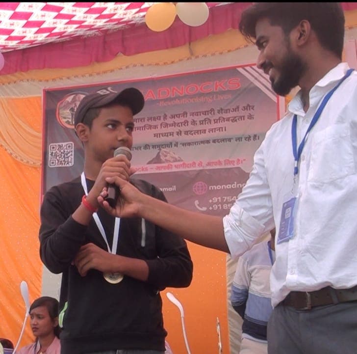 A student with his medal speaking on stage at the NCM Championship 2025